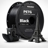 Spool of black PETG filament with 3D printed models on a white background