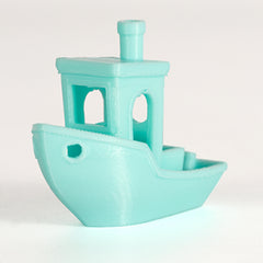 Turquoise toy boat on a white background