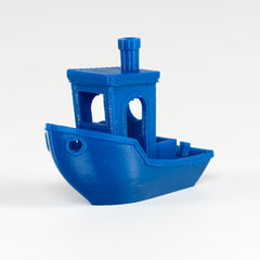 Blue toy boat on a white background