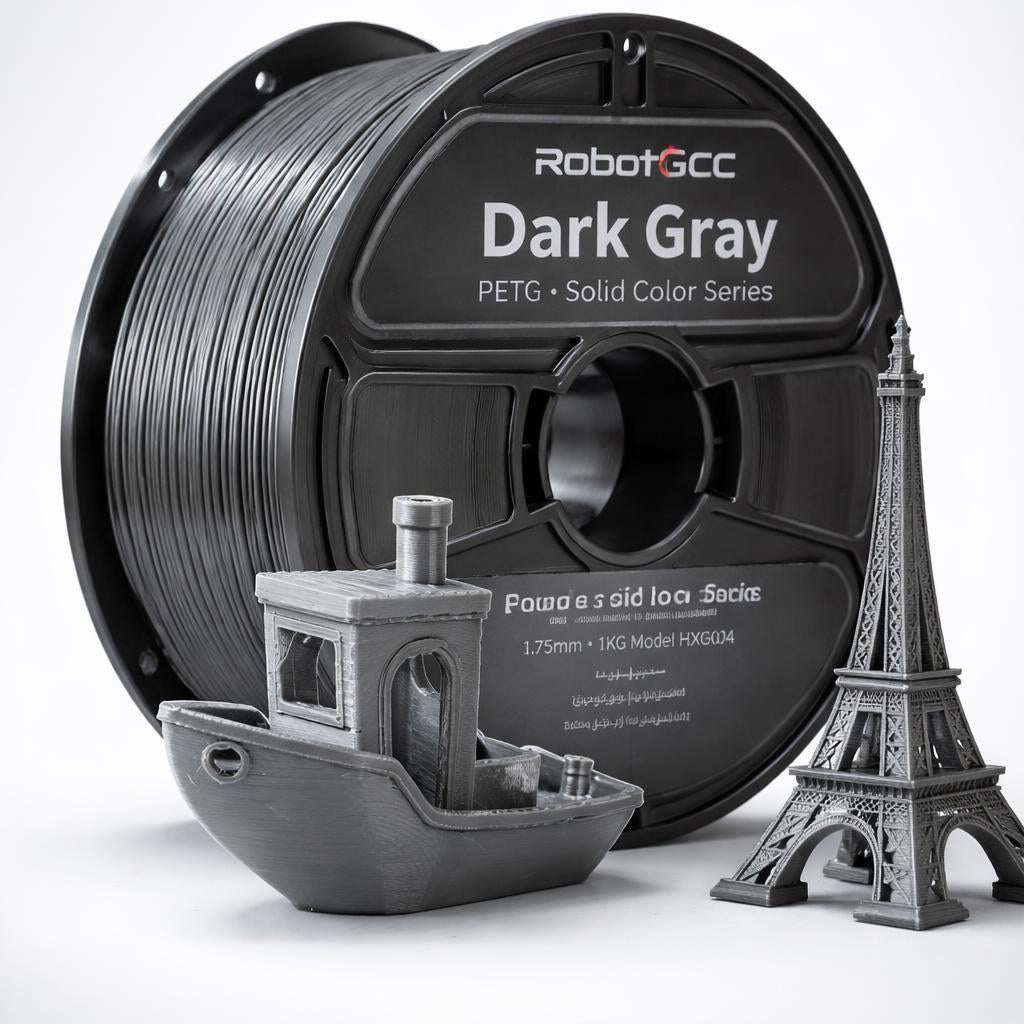 Spool of RobotGCC gray 3D printing filament with printed models on a white background