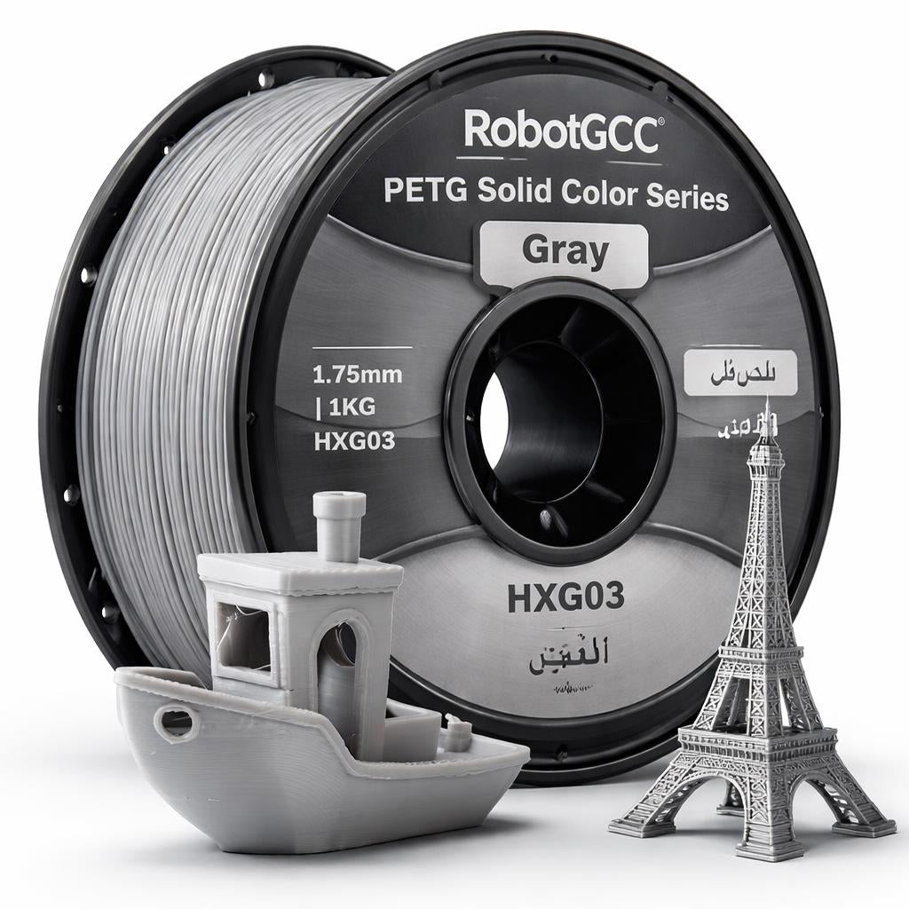 Spool of RobotGCC gray 3D printing filament with printed models on a white background