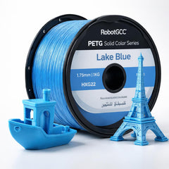 Spool of RobotGCC Lake Blue PETG filament with 3D printed models on a white background