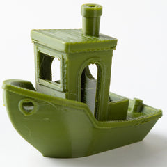 Green 3D-printed model of a ship on a white background