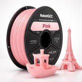 Spool of RobotGCC wheat yellow 3D printing filament with small models on a white background
