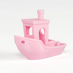 Pink toy boat on a white background