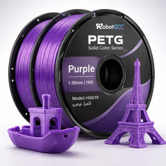 Purple 3D printing filament spool with 3D models of a boat and Eiffel Tower on a white background