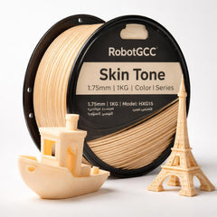 Spool of RobotGCC soft yellow 3D printing filament with 3D prints of a boat and Eiffel Tower.
