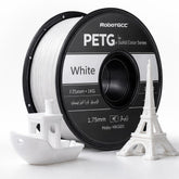 Spool of white 3D printing filament with a small model structure on a white background