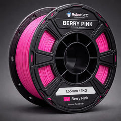Spool of Berry Pink 3D printing filament with printed objects on a white background
