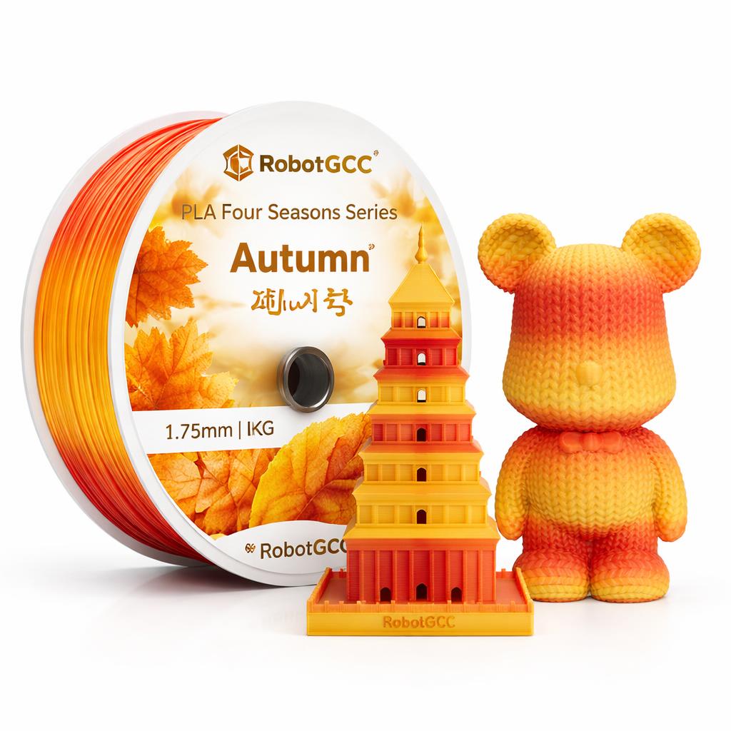 Spool of RobotGCC filament with autumn-themed design and a small model of a tower.