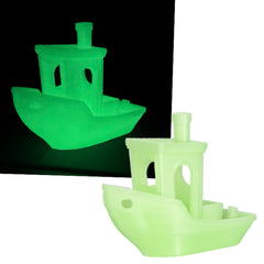 Two green toy boats on a white background