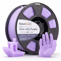 Spool of Glow Jelly Purple 3D printing filament with printed objects on a white background