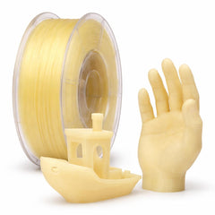 Spool of yellow filament with 3D printed objects on a white background