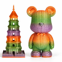 Colorful knit bear and tower-like structure on a white background