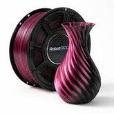 Spool of pink and black filament with a 3D printed vase on a white background, featuring the RobotGCC brand.