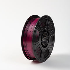 Spool of pink filament on a white background