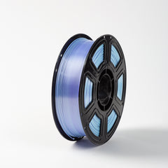 Spool of blue filament on a white background