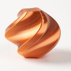 Copper-colored geometric object on a white background