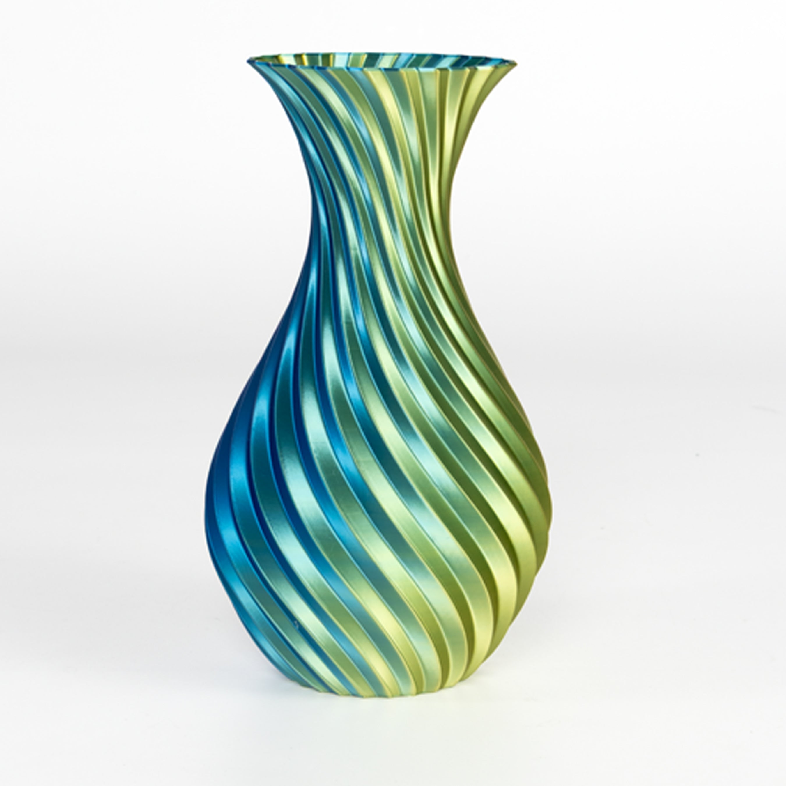 Glass vase with blue and green striped pattern on a white background