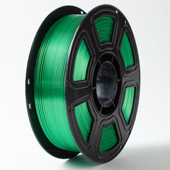 Spool of green filament on a white background