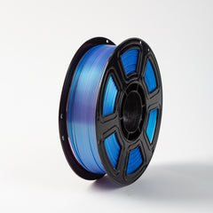 Spool of blue filament on a white background