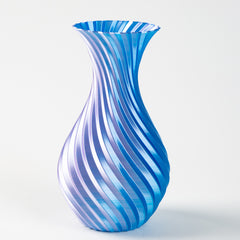 Blue and white striped glass vase on a light gray background
