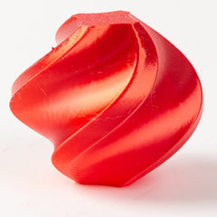 Red 3D-printed object on a white background