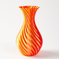 Decorative glass vase with orange and red swirl pattern on a white background