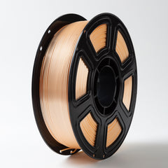 Spool of beige filament on a black plastic reel against a white background