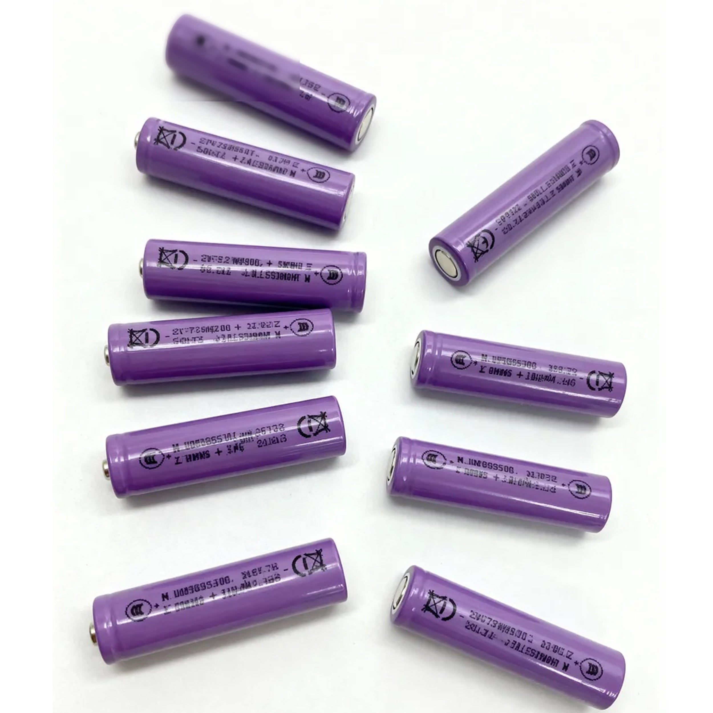 Purple batteries arranged on a white background
