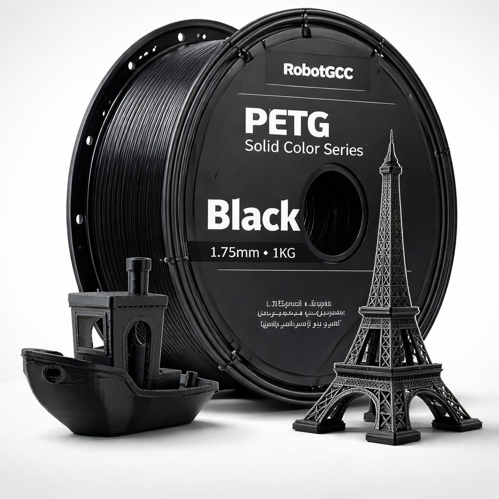 Spool of black PETG filament with 3D printed models on a white background