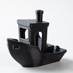 Black 3D-printed model of a ship on a white background