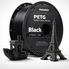 Spool of black PETG filament with 3D printed models on a white background