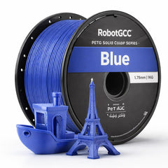Spool of pink 3D printing filament with a small pink Eiffel Tower and boat model on a white background.