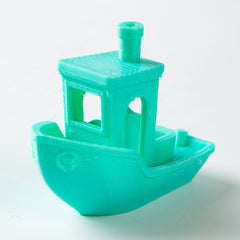 Turquoise toy boat on a white background