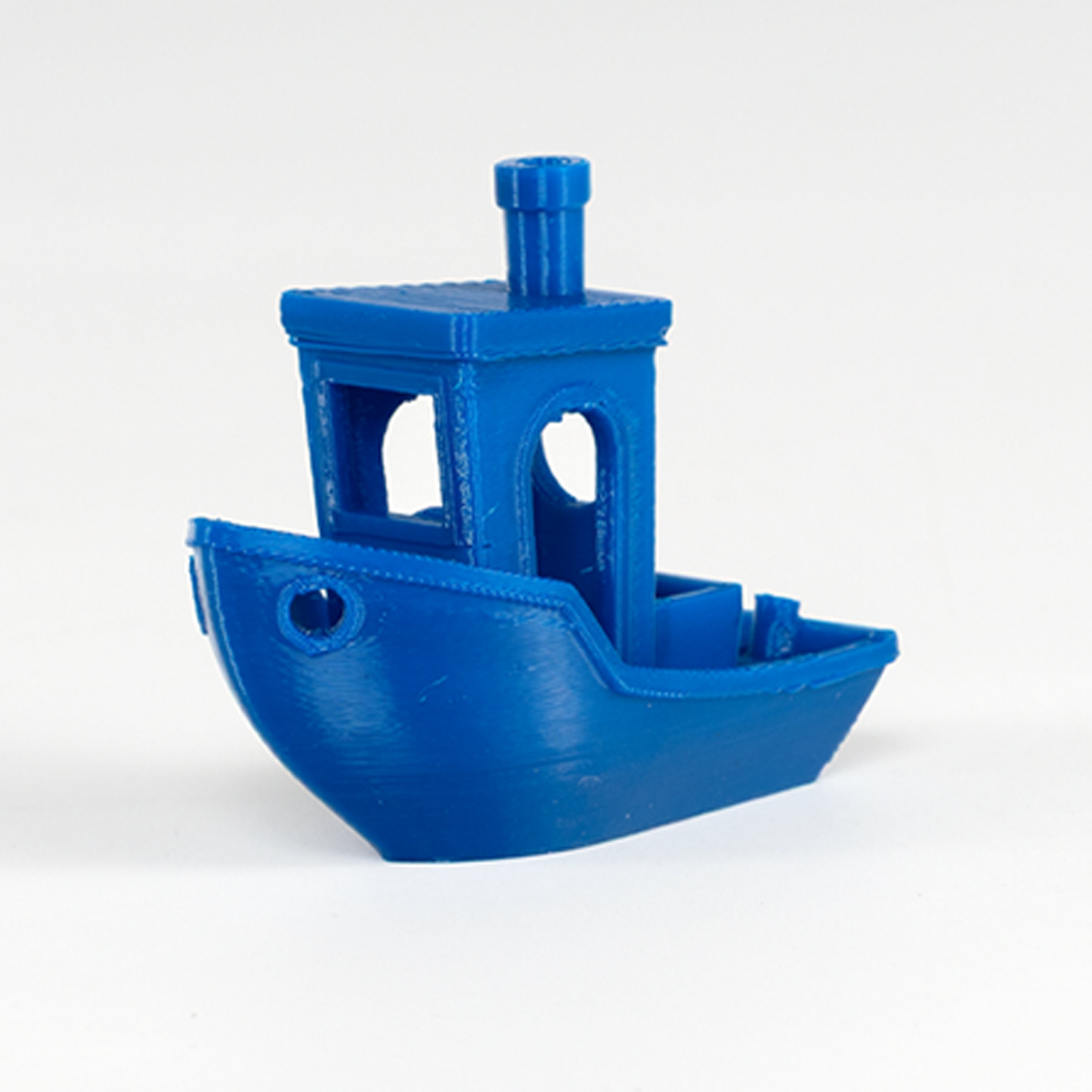 Blue toy boat on a white background