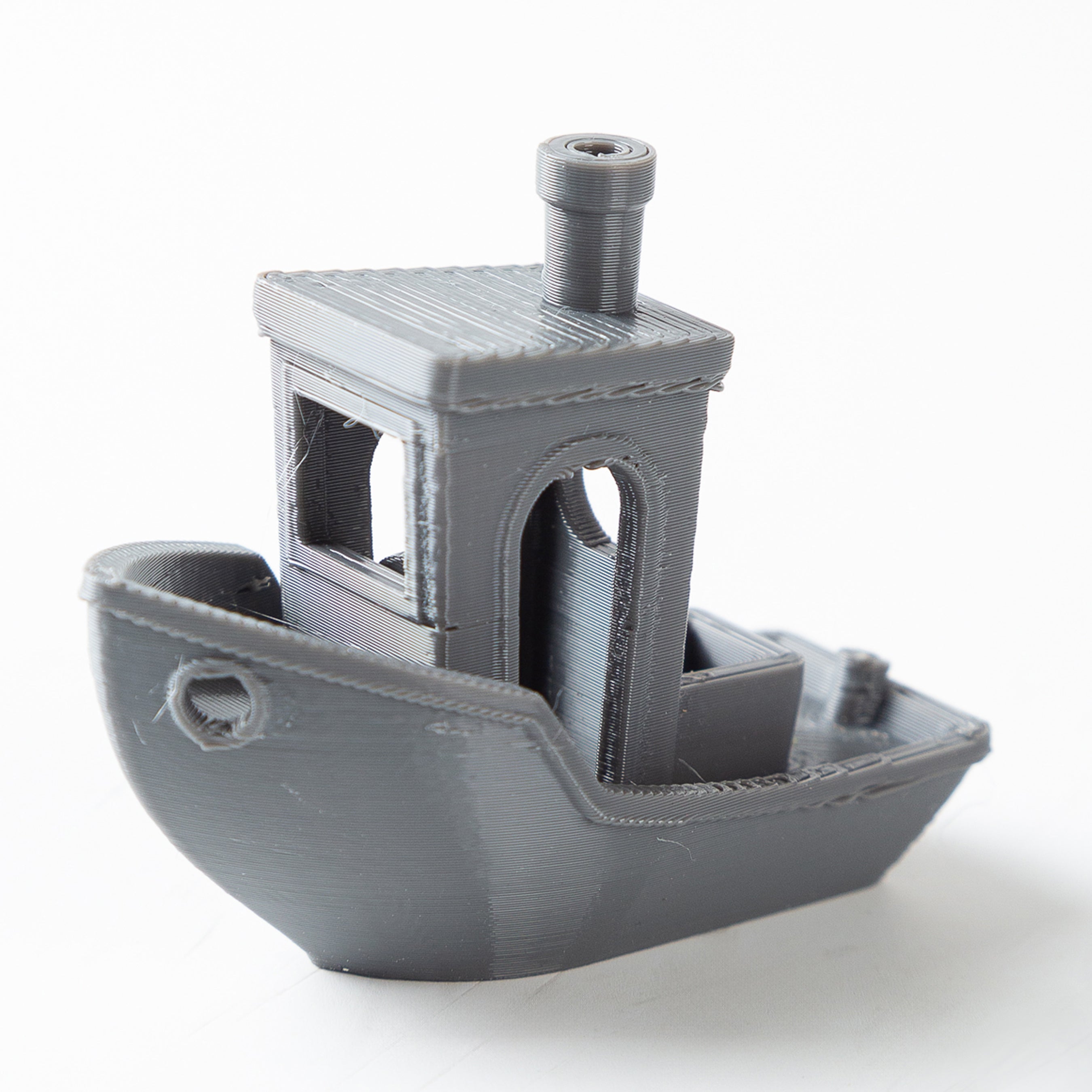 3D-printed model of a small ship on a white background