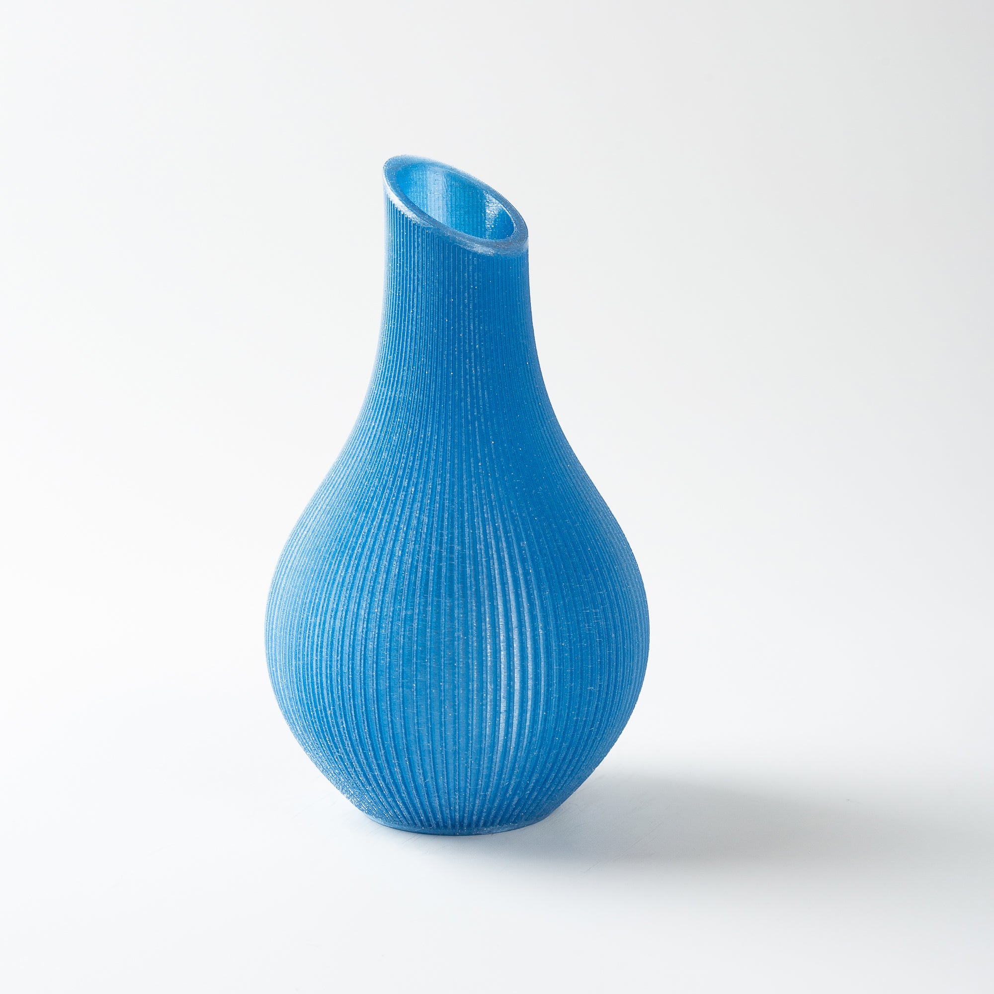 Blue textured vase on a white background