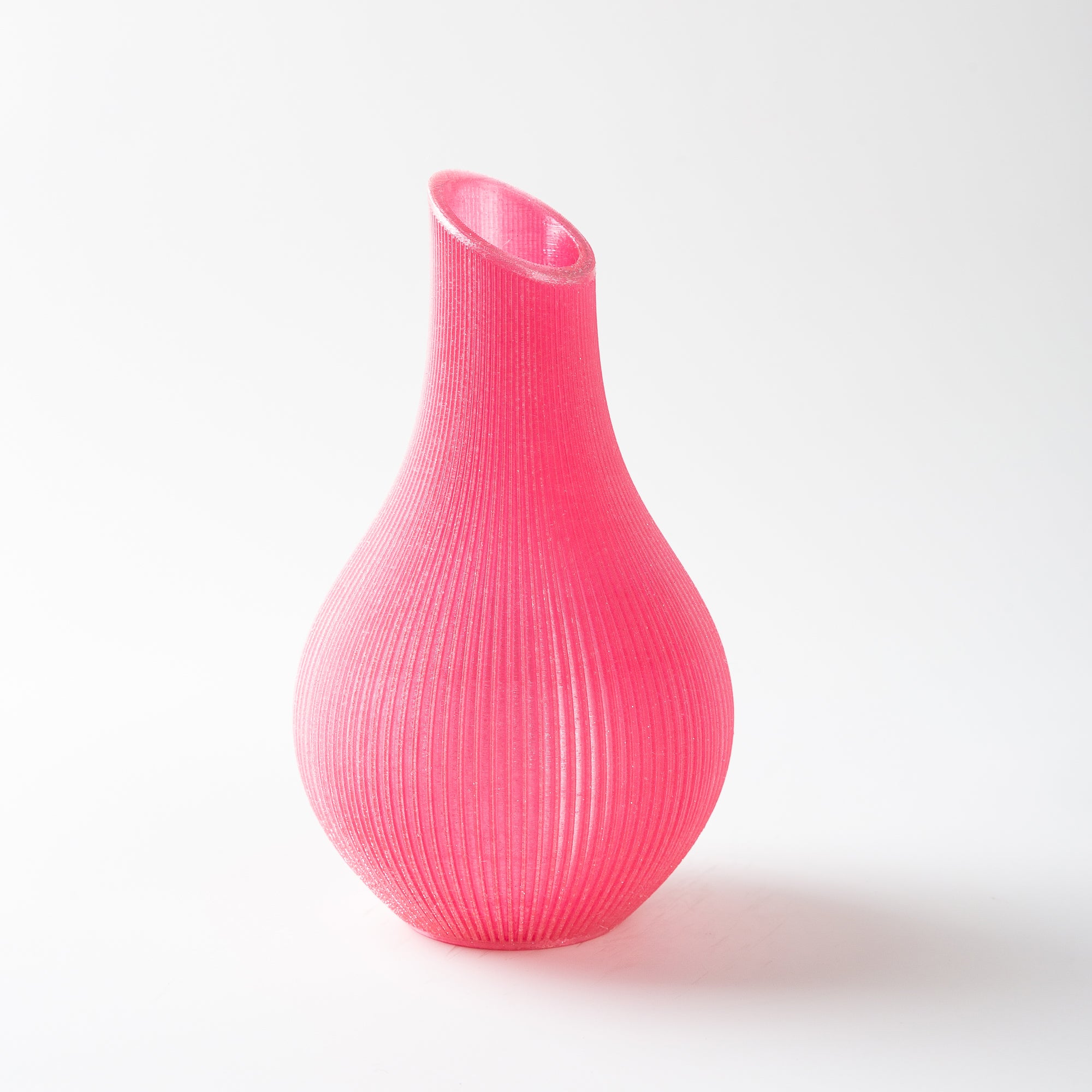Pink ribbed vase on a white background
