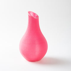 Pink ribbed vase on a white background
