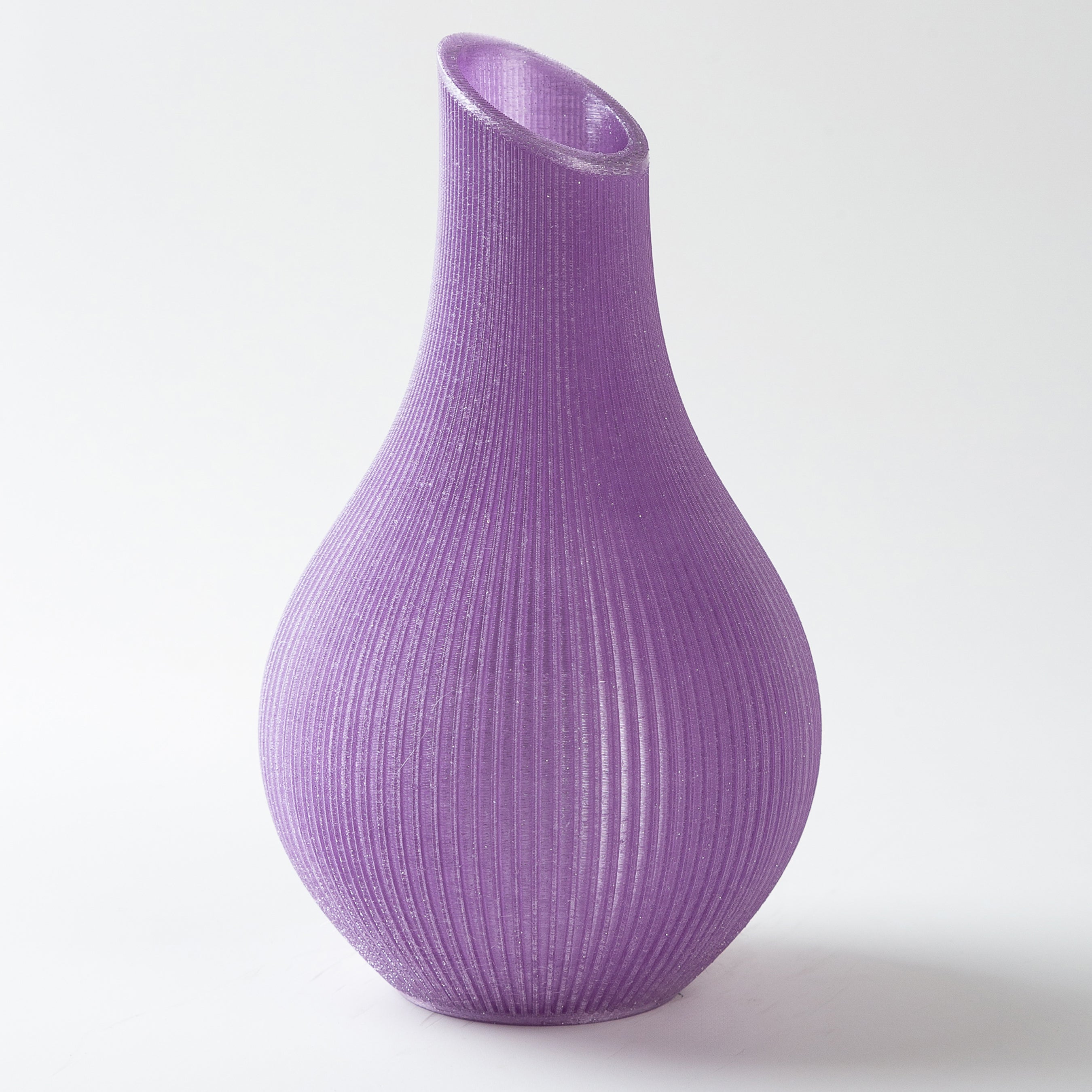 Purple ribbed vase on a white background
