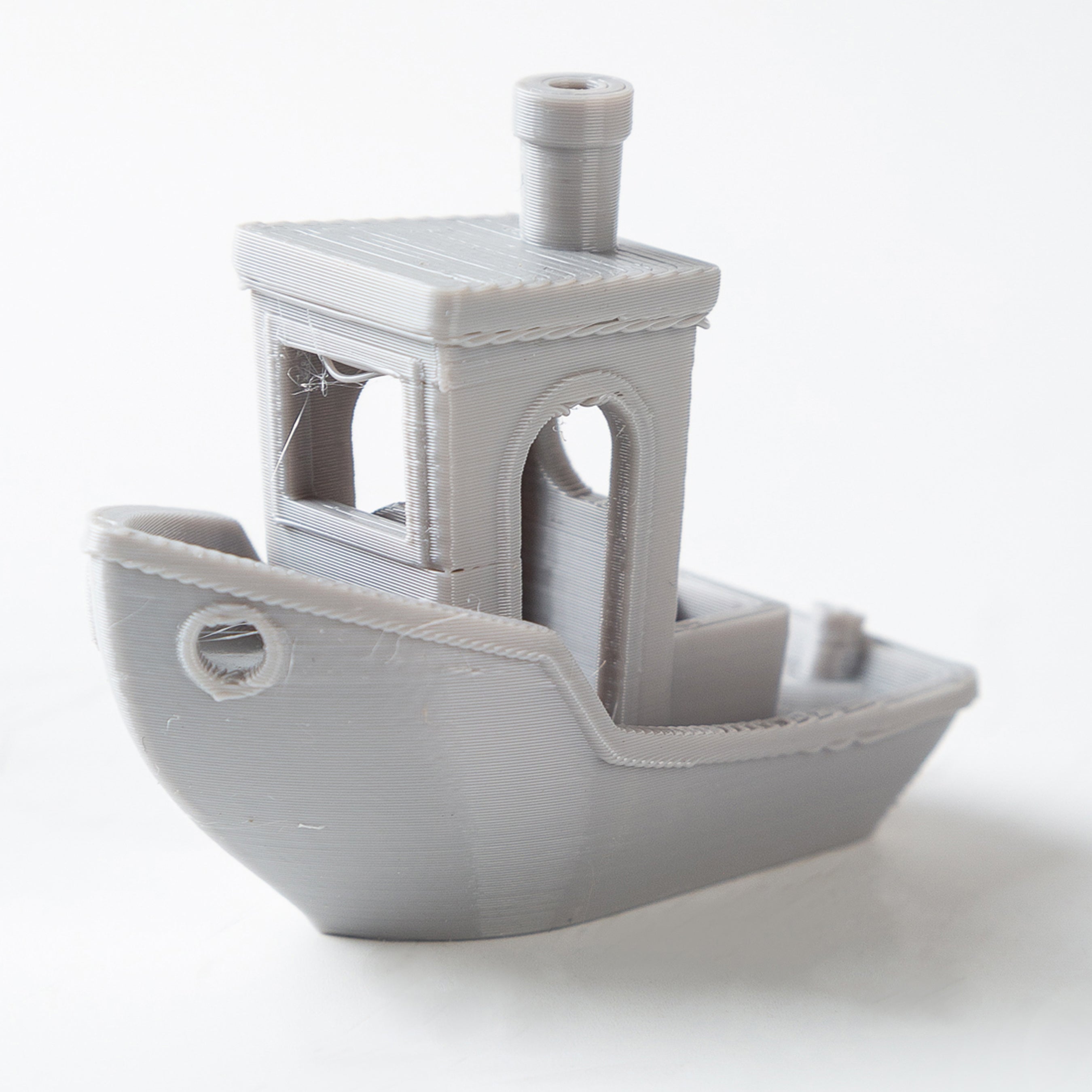 Gray toy boat on a white background