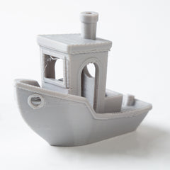 Gray toy boat on a white background