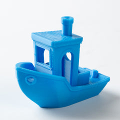 Blue toy boat on a white background