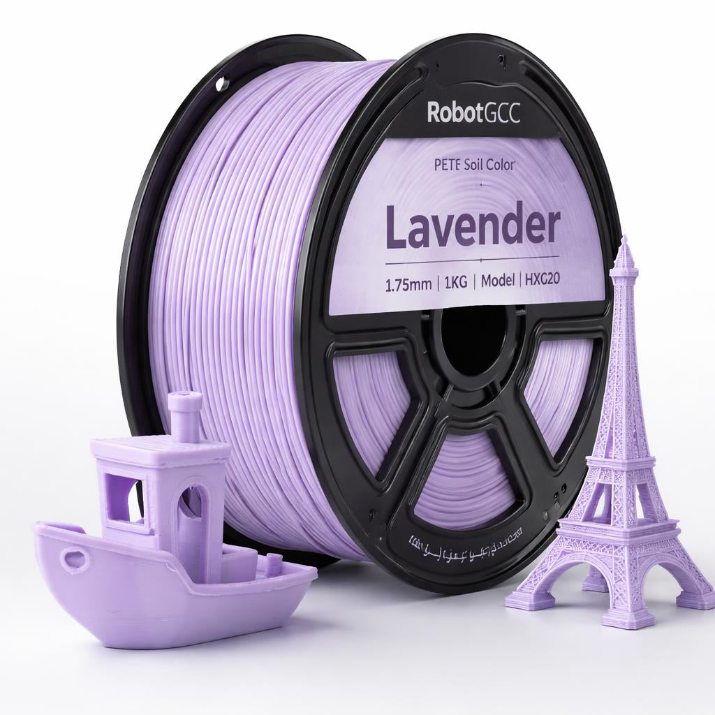 Spool of lavender 3D printing filament with models of a boat and Eiffel Tower made from it.