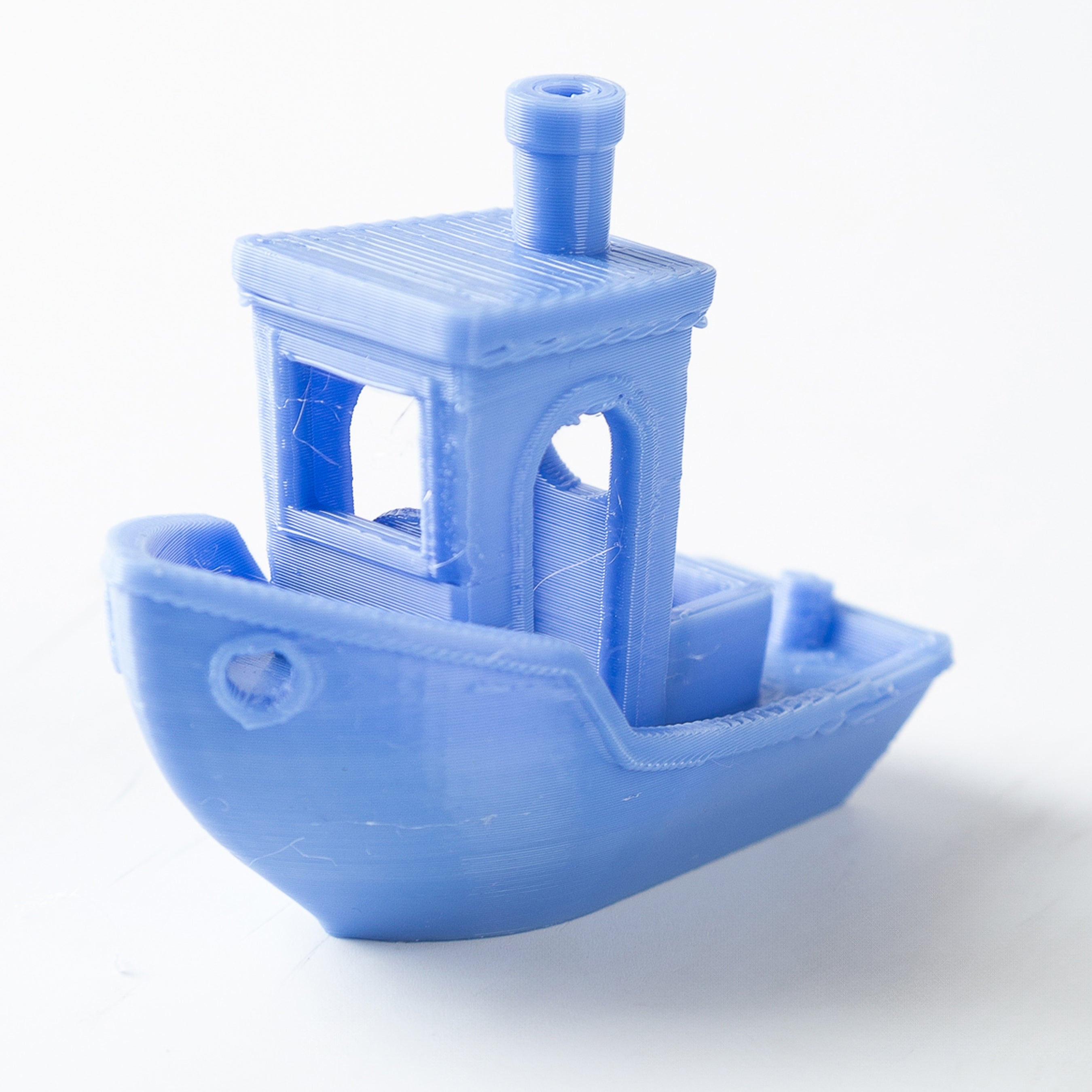 Blue toy boat model on a white background
