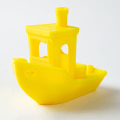 Yellow toy boat on a white background
