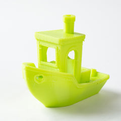 Green toy boat on a white background