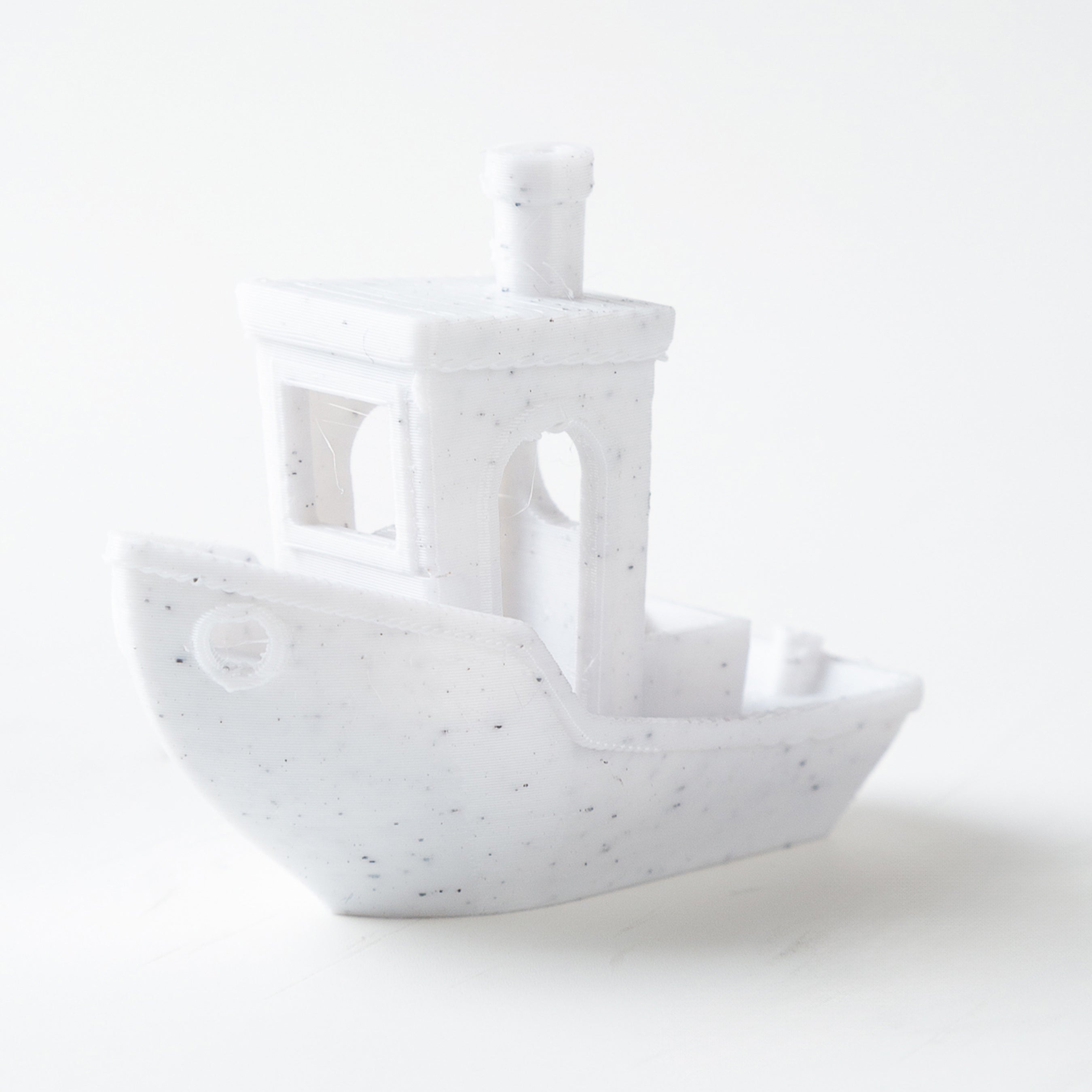 White ceramic ship-shaped object on a white background