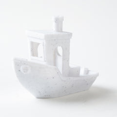 White ceramic ship-shaped object on a white background